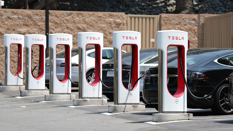 Teslas charging at Superchargers